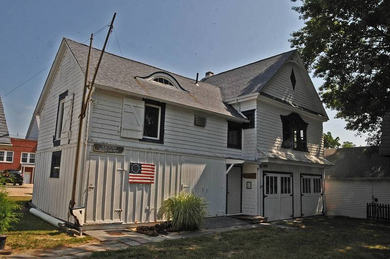 The white 1868 carriage house of the Toms River Seaport Society