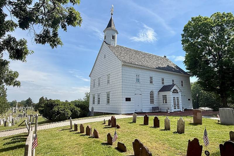 The white shingled Old Tennent Church and its cemetery